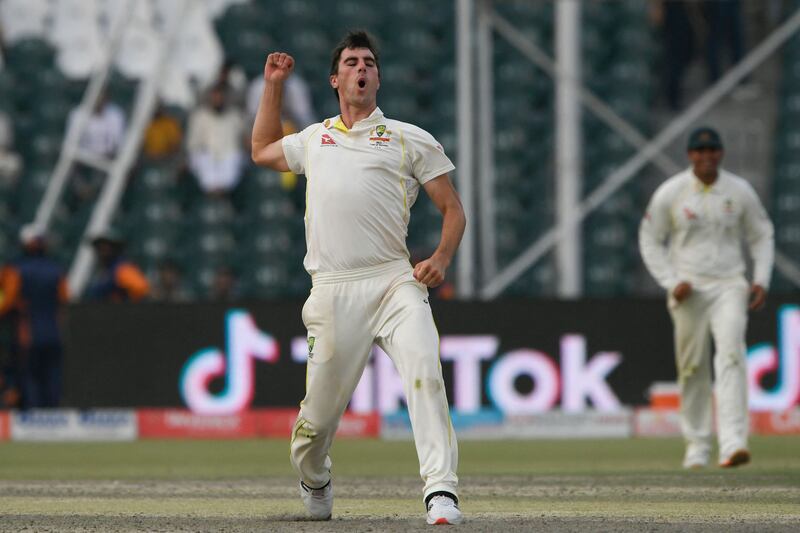 Australia captain Pat Cummins celebrates after taking the wicket of Pakistan's Nauman Ali during the third day of the third Test at the Gaddafi Stadium in Lahore on Wednesday, March 23, 2022. AFP