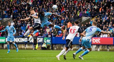 BOLTON, ENGLAND - AUGUST 10: Bolton Wanderers' Dennis Politic (2nd left) competing in the air with Coventry City's Fankaty Dabo during the Sky Bet League One match between Bolton Wanderers and Coventry City at University of Bolton Stadium on August 10, 2019 in Bolton, England. (Photo by Andrew Kearns - CameraSport via Getty Images)