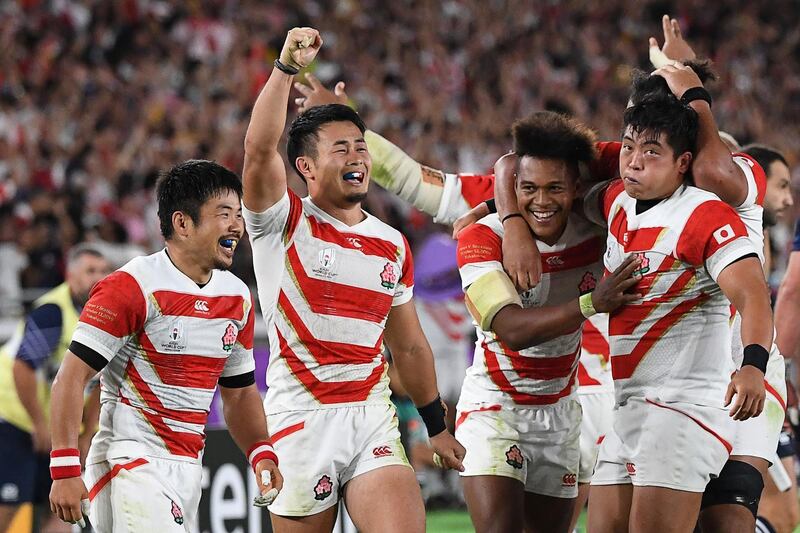 Japan players celebrate beating Scotland to secure a place in the Rugby World Cup quarter-finals. AFP