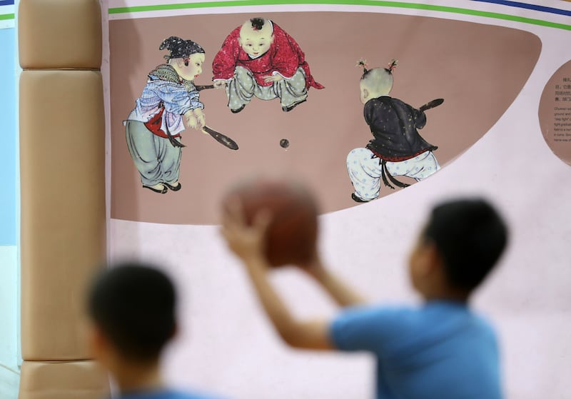 Images of traditional games are displayed on the walls of a sports hall at the school