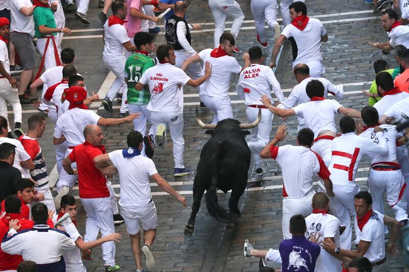 Revellers sprint in front of a bull during the third day of the running of the bulls at the San Fermin festival in Pamplona, Spain. Susana Vera / Reuters