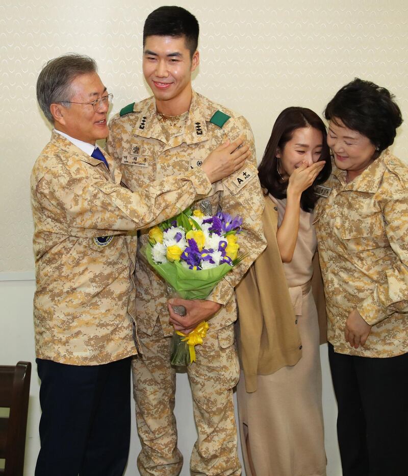 South Korean President Moon Jae-in and his wife Kim Jung-sook embrace Captain Lee Jae-woo and his fiancee Lee Dabomi in a gesture congratulating the couple on their planned marriage, as he visits a contingent of the Akh unit. EPA / Yonhap