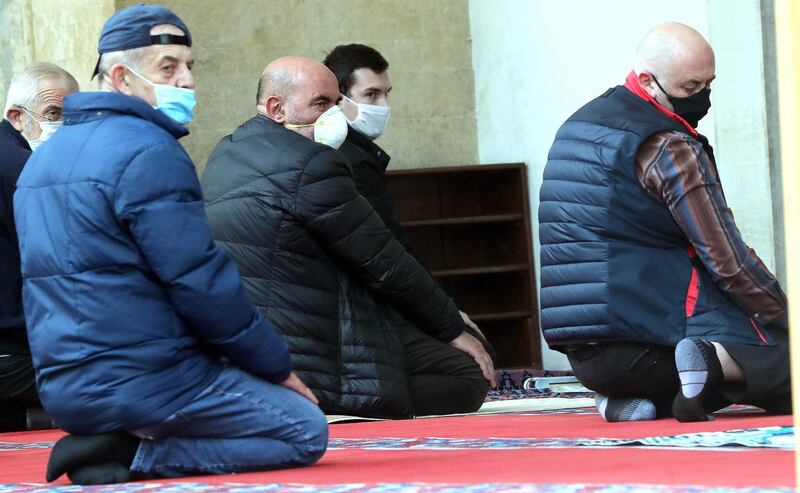 Bosnian Muslim men wearing protective face masks pray in the Gazi Husrev-beg Mosque in Sarajevo, Bosnia and Herzegovina. EPA