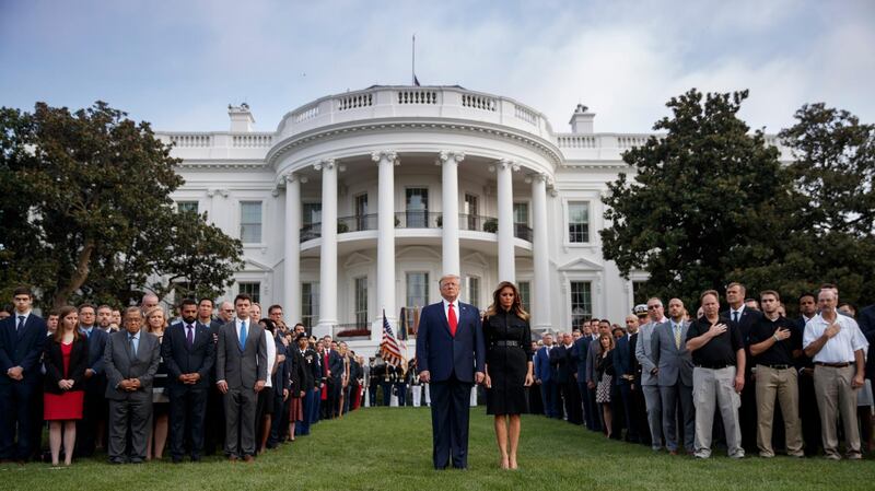 epa07835192 US President Donald J. Trump (L) and First Lady Melania Trump observe a moment of silence on the 18th anniversary of the 9/11 terrorist attacks at the White House in Washington, DC, USA, 11 September 2019. President Trump and the First Lady will participate in the Pentagon 9/11 ceremony later in the morning.  EPA/SHAWN THEW