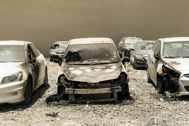 DUBAI, UNITED ARAB EMIRATES - AUG 4: 

Dubai Marina's Torch Tower, one of the world's tallest residential buildings, went up in a fire that started last night. 

Many of the cars parked close where damaged because of the burning debris. 

(Photo by Reem Mohammed/The National)

Section: NA