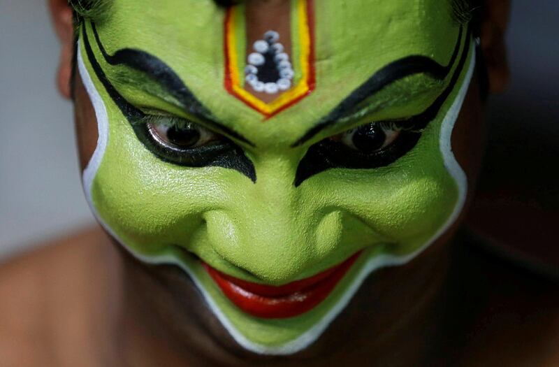 An artist gets ready backstage to perform an Indian art form of dance called 'Ottamthullal' at the annual eight-day long Vrischikolsavam festival, which features a colourful procession of decorated elephants along with drum and trumpets concerts, at Sree Poornathrayeesa temple in Kochi, India.  Reuters