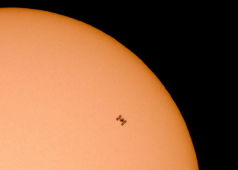 The International Space Station (ISS) flies in front of the Sun as seen from the vicinity of Gyongyos, Hungary. EPA