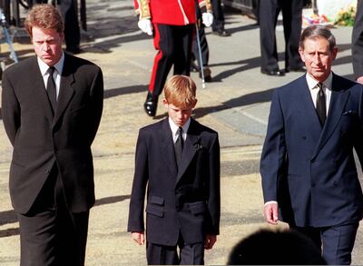 (FILES) In this file photo taken on September 06, 1997 (L to R) Earl Spencer, Diana's brother, Prince Harry, her son, and Prince Charles, her former husband, join the gun carriage carrying the coffin of Princess of Wales at Marlboro Road in London during the funeral. Scarred by the death of his mother, Prince Harry has struggled in the royal limelight for much of his life, and his fears for wife Meghan have now put him at loggerheads with his family. / AFP / Gerry PENNY
