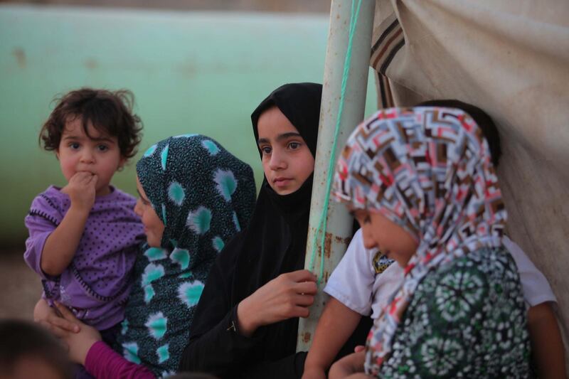 In this Aug. 4, 2014, photo, displaced Iraqi children who fled with their families from Mosul and other towns after advances by Islamic militants take shelter in Najaf, Iraq. Some 50,000 newly displaced Shiite Turkmen arrived the Shiite holy city of Najaf, where they are safe for now _ but not without extreme hardship. They journeyed several hours across Iraq's sprawling deserts. Some traveled without food or water in the blistering heat made worse by an overcrowded buses of hysterical refugees _ many of them far less fortunate, having lost a relative or two at the hands of the unforgiving militants who view them as apostates. (AP Photo/Jaber al-Helo)