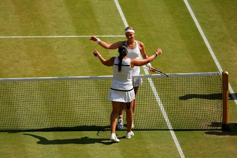 LONDON, ENGLAND - JULY 06:  Marion Bartoli of France embraces Sabine Lisicki of Germany at the net after their Ladies' Singles final match on day twelve of the Wimbledon Lawn Tennis Championships at the All England Lawn Tennis and Croquet Club on July 6, 2013 in London, England.  (Photo by Julian Finney/Getty Images) *** Local Caption ***  173068857.jpg