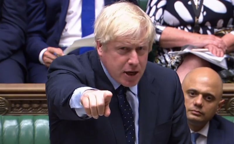 Johnson gestures at the dispatch box and speaks in the House of Commons. PRU / AFP