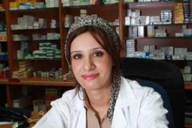 DUBAI, UNITED ARAB EMIRATES - MARCH 01:  Ruba Al-Bdour, a pharmacist at the Ghazal Jumeirah Pharmacy, at her workplace in Dubai on February 28, 2009.    (Randi Sokoloff / The National)  For personal finance story, Money&Me by Vinita. *** Local Caption ***  RS006-030109-RUBA.jpg