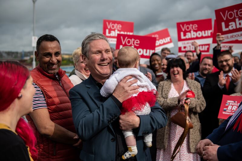 Labour party leader Keir Starmer holds a baby in Medway, where his party won the local election. Getty