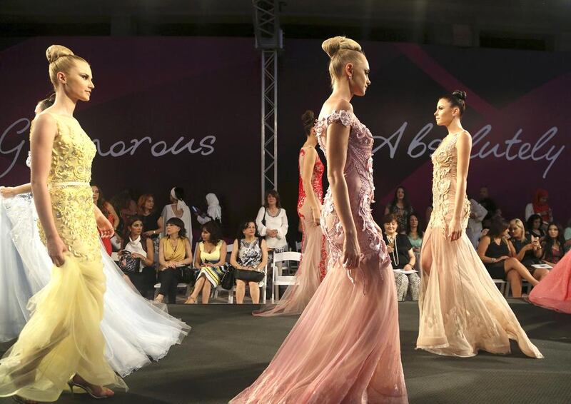 Models display creations by the Emirati designer Mona al-Mansouri of her Spring-Summer 2015 fashion show during the summer fashion week at Saint George Yacht Club in Beirut. Hussein Malla / AP photo