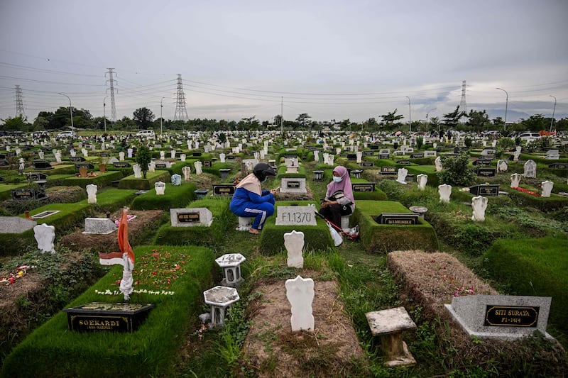 People visit the graves of family members in Surabaya, during a tradition before the start of Ramadan. AFP