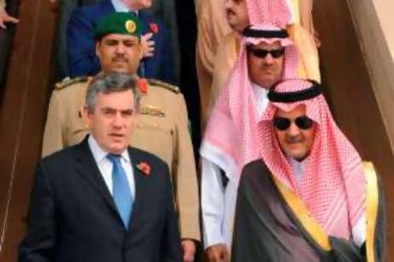 Prime Minister Gordon Brown, front left, with Saudi Foreign Minister Prince Saud Al Faisal, front right, at Riyadh Airport before boarding his plane bound for Doha in Qatar Sunday Nov. 2, 2008. Brown said Sunday he expects Saudi Arabia to contribute to the International Monetary Fund's bailout reserves after he promised business leaders in the Gulf that they would have a say in any future new world economic order.  (AP Photo/Stefan Rousseau/PA Wire) ** UNITED KINGDOM OUT NO SALES NO ARCHIVE ** *** Local Caption ***  LON805_GULF_BROWN.jpg
