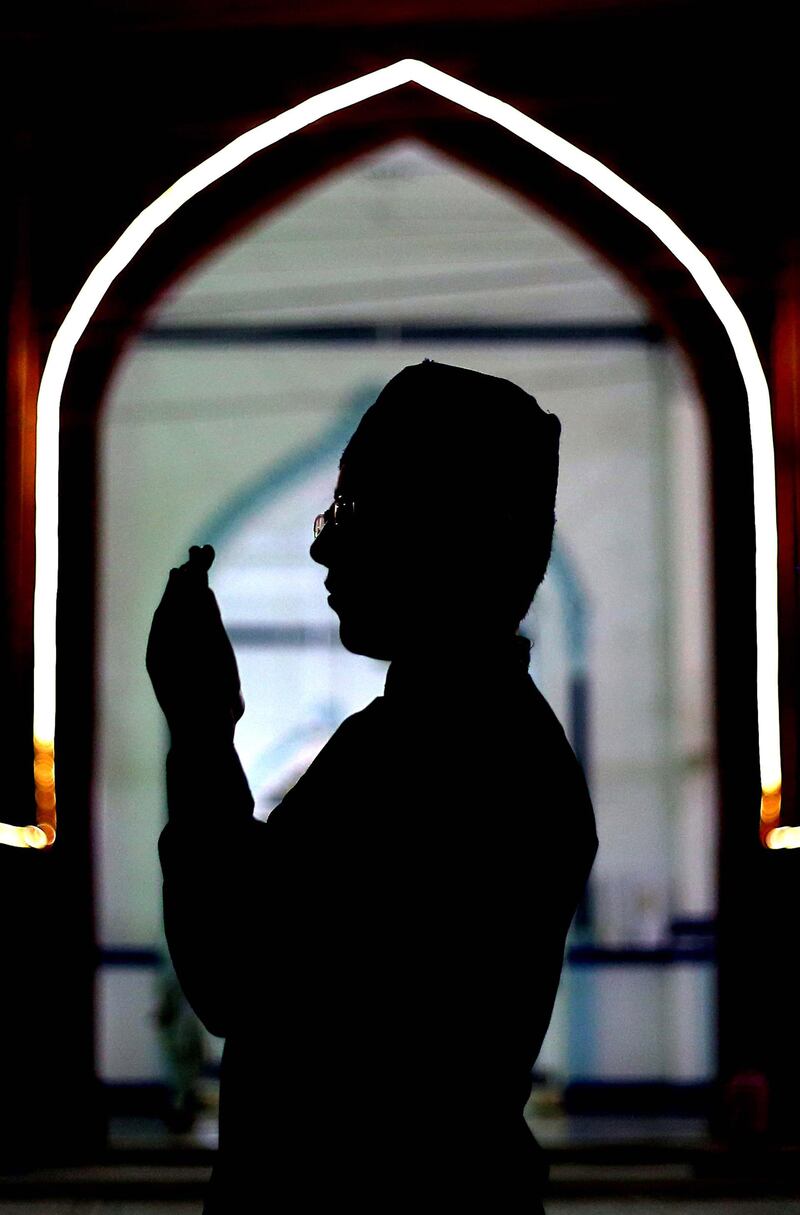 A boy prays during the holy holy fasting month of Ramadan, in Karachi, Pakistan. EPA