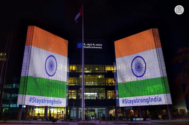 The Indian flag along with the message '#STAYSTRONGINDIA' is projected onto the exterior of Khalifa University in Abu Dhabi. Abu Dhabi Media Office