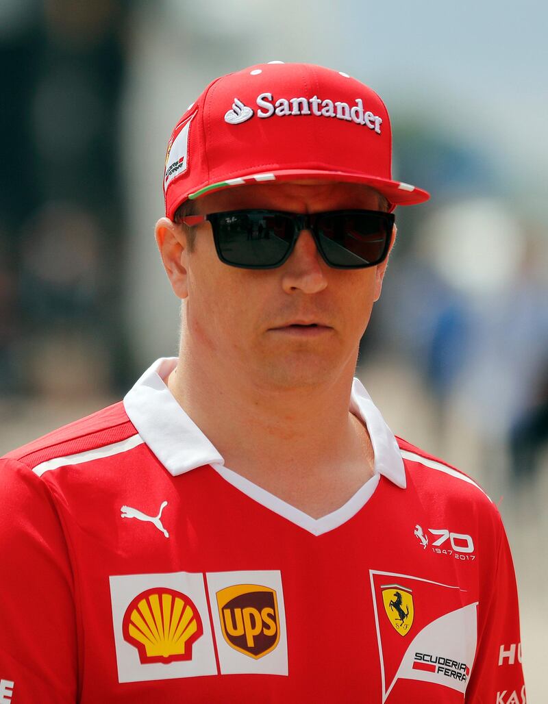 In this July 13, 2017 photo, Ferrari driver Kimi Raikkonen of Finland arrives at the Silverstone circuit for the British Formula One Grand Prix, Silverstone, England. Ferrari on Tuesday, Aug. 22, 2107 announced that Raikkonen has signed a one-year extension to his contract at Ferrari and will race for the Italian team in the 2018 Formula One world championship. (AP Photo/Frank Augstein)
