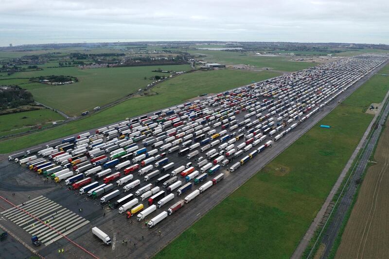 DOVER, ENGLAND - DECEMBER 22: Lorries are parked on the runway at Manston airport at sunrise as part of Operation Brock to stack lorries waiting to cross the English Channel on December 22, 2020 in Ramsgate, United Kingdom. Nearly 1000 lorries remained stacked up in Kent as drivers waited for a resumption of travel from the port of Dover to France. On Sunday, France abruptly halted freight and passenger travel from the UK over concerns about the UK's surging covid-19 cases and a new variant of the virus.  (Photo by Dan Kitwood/Getty Images)