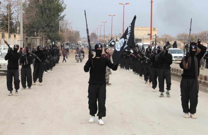 Fighters of al-Qaeda linked Islamic State of Iraq and the Levant carry their weapons during a parade at the Syrian town of Tel Abyad, near the border with Turkey January 2, 2014. Picture taken January 2, 2014. REUTERS/Yaser Al-Khodor (SYRIA - Tags: POLITICS CIVIL UNREST CONFLICT)
