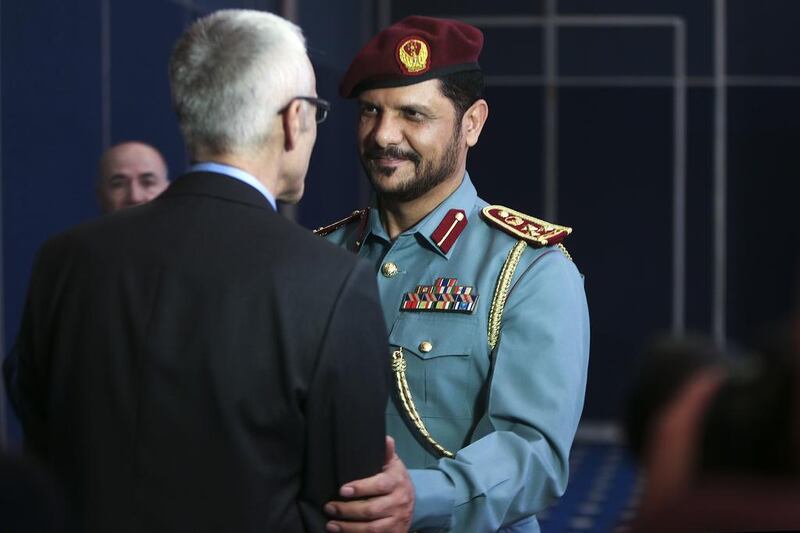 Brig Hamad Al Amimi greets Jurgen Stock, Interpol’s secretary general, on Monday ahead of the Unity for Security Forum at the Abu Dhabi National Exhibition Center. Delores Johnson / The National