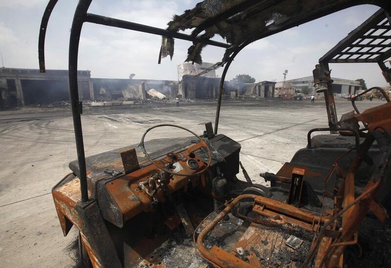 Damaged vehicles are left on the tarmac after Sunday’s attack. Athar Hussain/Reuters