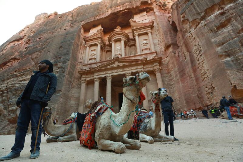 Jordanians offer camel rides for tourists in front of the ancient Khaznah (treasury) monument. AFP