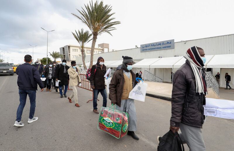 Sudanese migrants carrying their luggage stand in line at the Mitiga airport in the Libyan capital Tripoli, before flying back to their country voluntarily. AFP