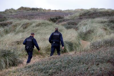 French police patrol the dunes in Wimereux, near Calais, at France's northern tip. Reuters