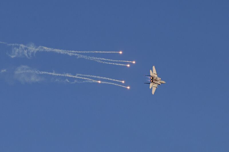 An Israeli air force F-15 fighter jet drops decoy flares during an air display over the Negev desert in Israel. AFP