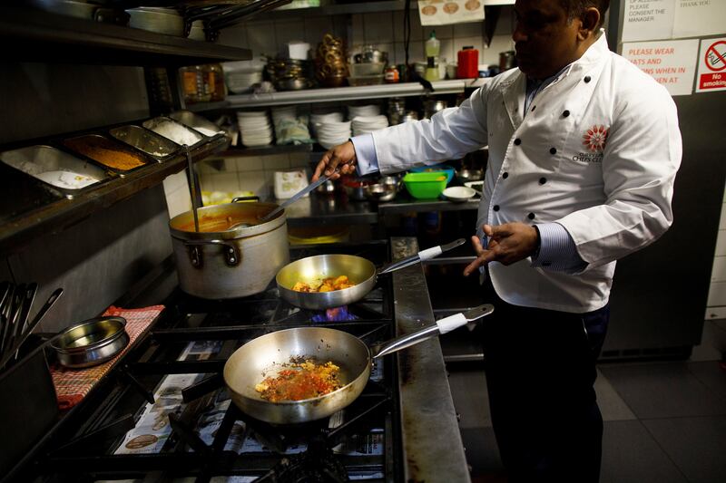 Abdul Ahad, owner of the City Spice curry house, cooks a vegan meal on Brick Lane in London. Reuters