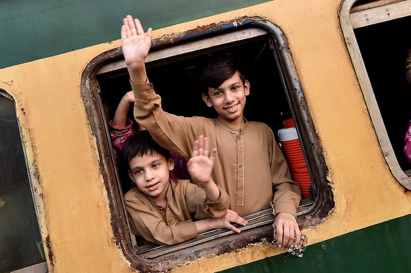 Children get set for the train journey back to their homes to celebrate Eid Al Fitr in Karachi, Pakistan. EPA