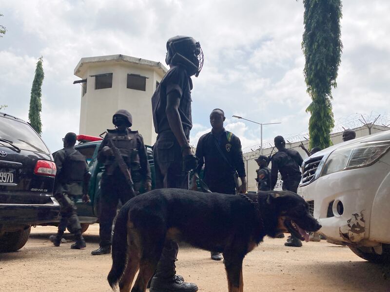 Officers stand guard outside the Kuje prison. AP