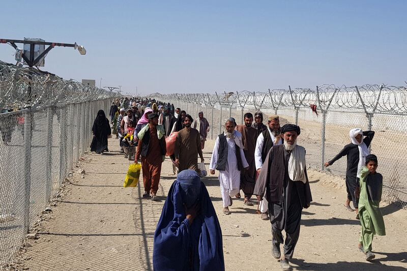 Afghans make their way into Pakistan at the Chaman border crossing. AFP