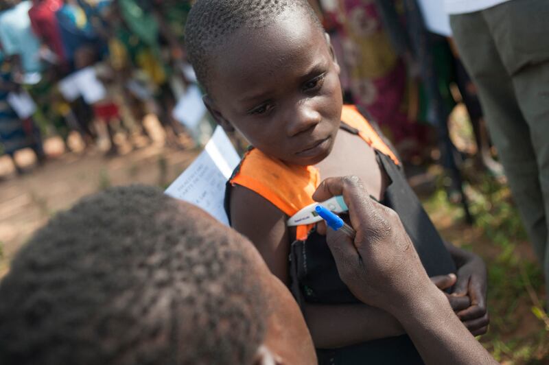 A member of the Doctors without Borders examines a child as part of a campaign against malaria on the outskirts of Bambari in Central African Republic. AFP