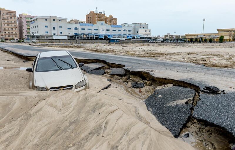 epa07166891 A car is swept away on a damaged road following heavy rain in Kuwait City, Kuwait, 15 November 2018. Kuwaiti government suspended work at ministries, public and private schools on 15 November due to unstable rainy weather.  EPA/NOUFAL IBRAHIM