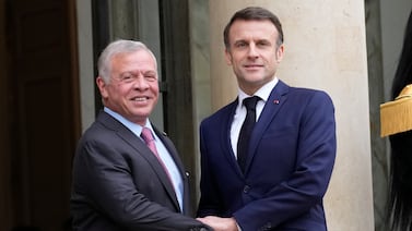 Jordan's King Abdullah, left, is received by French President Emmanuel Macron, at the Elysee Palace in Paris. AP
