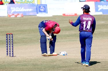 Vriitya Aravind of UAE looks in pain during match between the United Arab Emirates and Nepal in the semifinals of ICC Men's T20 World Cup Final Asia in Mulpani Cricket Ground, Kathmandu on Fr