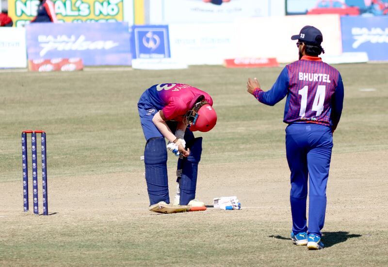 Vriitya Aravind nurses his already injured hand after being struck by the ball in UAE's defeat to Nepal at the T20 World Cup Qualifier. Subas Humagain for The National