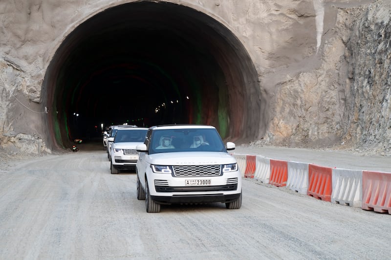 Sheikh Hamad bin Mohammed and Sheikh Theyab bin Mohamed, in front vehicle, emerge from the newly built tunnel.