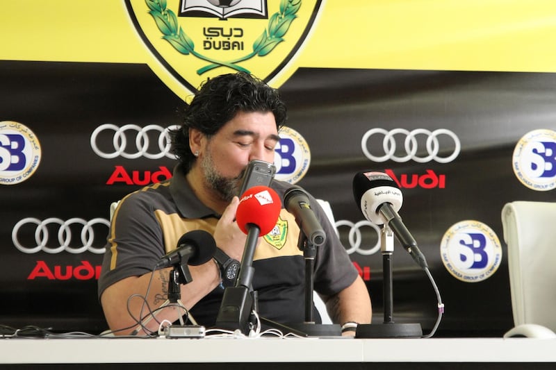 Diego Maradona kisses his phone when he took the call from grandson during the press conference. Courtesy Tariq Al-Sharabi