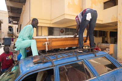 People in St Louis, Senegal, move the coffin of their friend, Abdou Diop, who died trying to migrate to Europe. AP