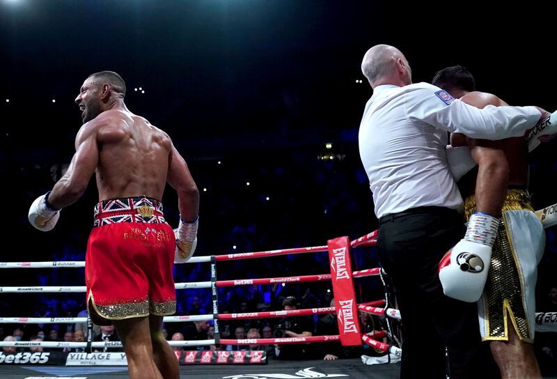 Kell Brook, left, celebrates after the referee stepped in to end the fight against Amir Khan in round six. AP