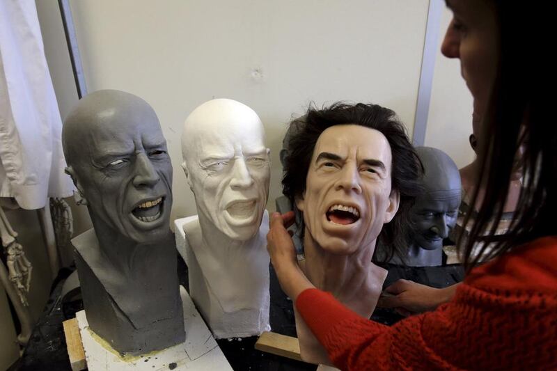 Helene Jonca, one of the painters at the Paris Grevin Wax Museum checks the wax statue of Rolling Stones lead singer Mick Jagger in their workshop in Paris on April 4, 2014. Philippe Wojazer / Reuters