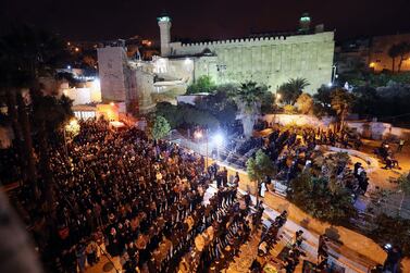 Palestinian Muslim worshippers gather for an early morning prayer service around the Ibrahimi mosque or the Tomb of the Patriarch in Hebron, West Bank. EPA