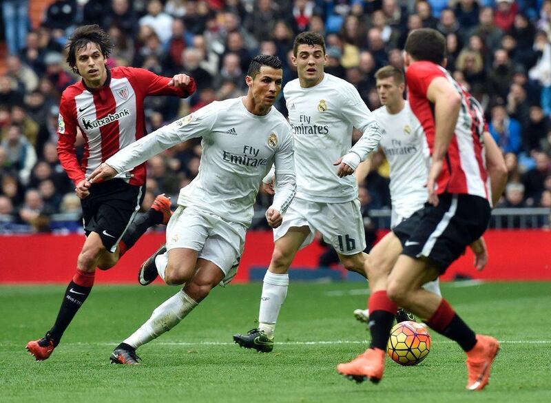Real Madrid's Cristiano Ronaldo, second from left, runs with the ball during their La Liga match against Athletic Club Bilbao at the Santiago Bernabeu stadium in Madrid on February 13, 2016. / AFP / GERARD JULIEN