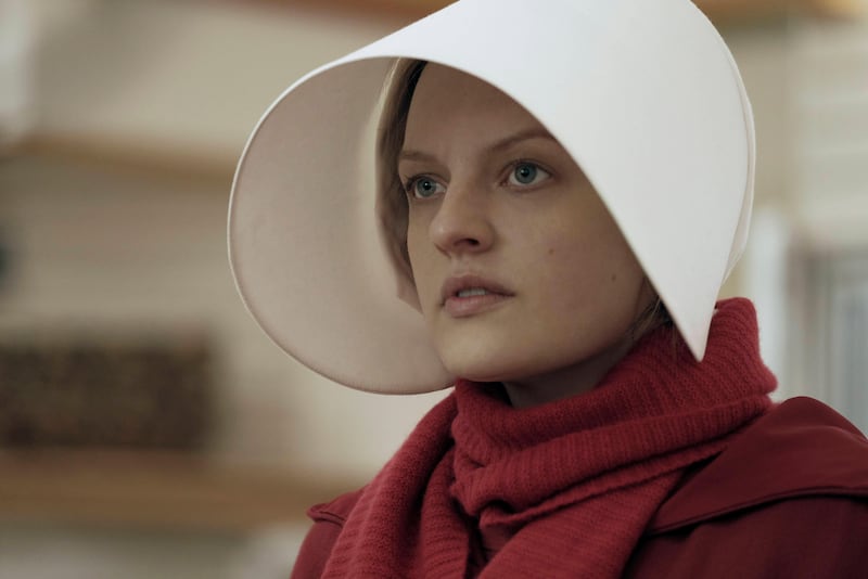 This image released by Hulu shows Elisabeth Moss as Offred in a scene from, "The Handmaid's Tale." Moss is nominated for an Emmy Award for outstanding lead actress in a drama series .  The Emmy Awards ceremony, will air on Sept. 17. (George Kraychyk/Hulu via AP)