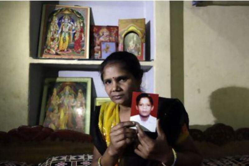 Pravesh Kumari Singh, 36, shows a photo of her son, Pankaj, 14, who went missing in 2010, from her house in New Delhi. More than 90,000 children go missing in India each year.