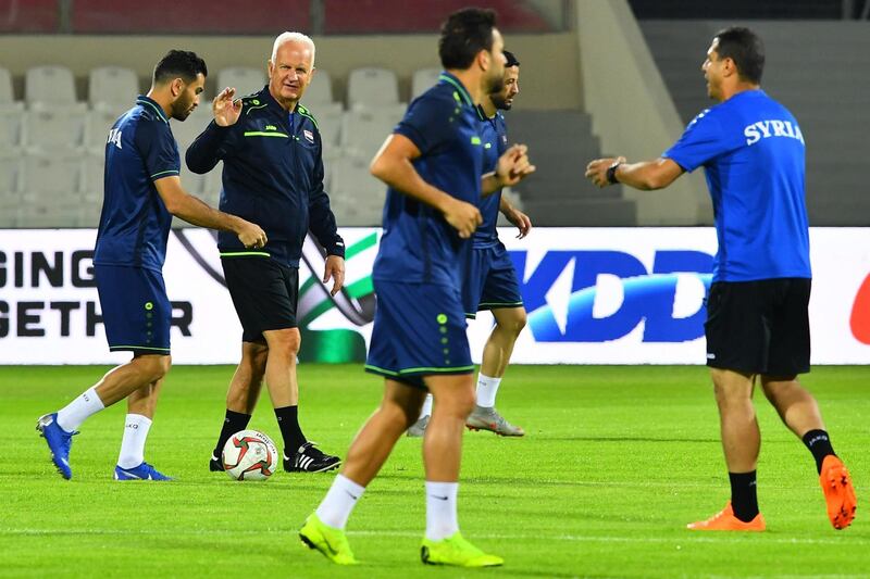 Syria's German coach Bernd Stange (2nd-L) attends a training session with his players at Sharjah stadium in Sharjah on January 5, 2019, a day ahead of his team's match against Palestine in the 2019 AFC Asian Cup football tournament. / AFP / GIUSEPPE CACACE

